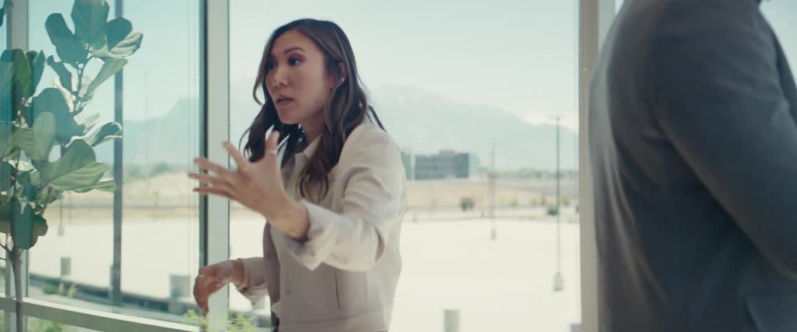 Woman in an office room talking to a man next to her