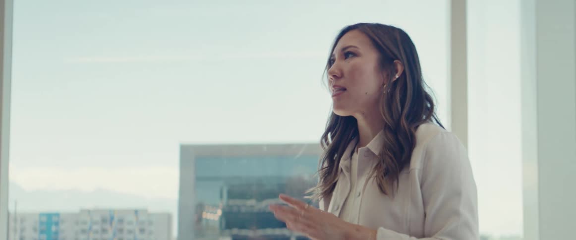 An asian woman and a black man collaborate in an office setting