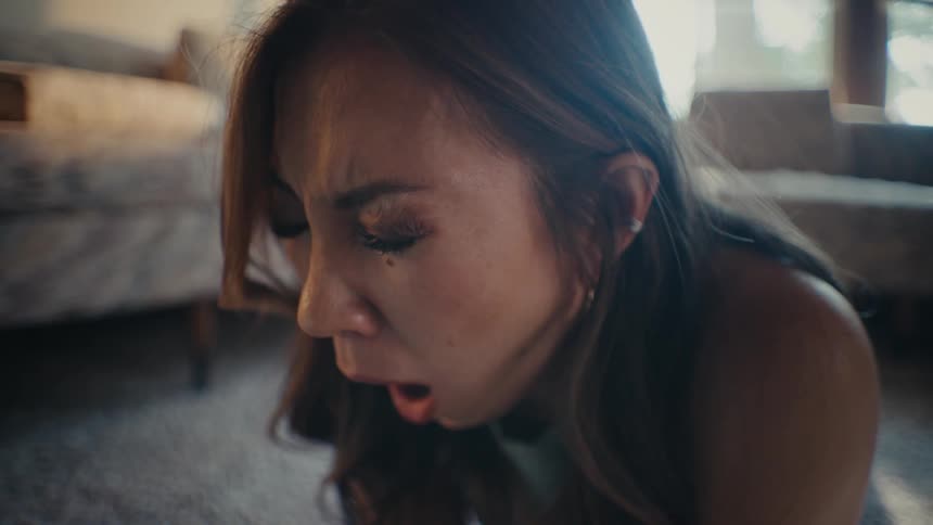 A woman laying on the floor yawns