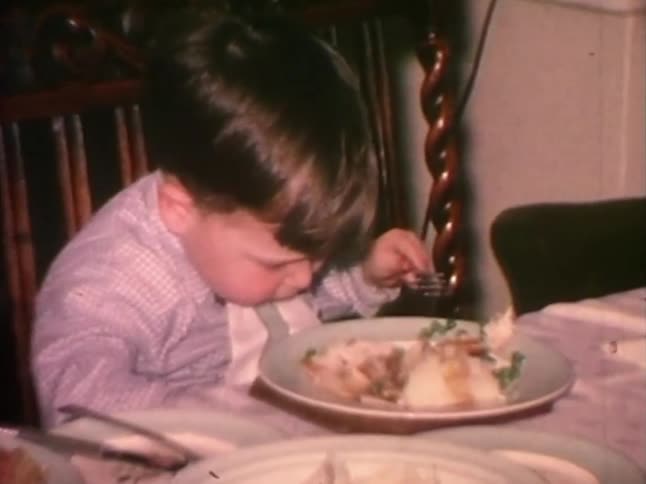 Little boy eating at the dinner table