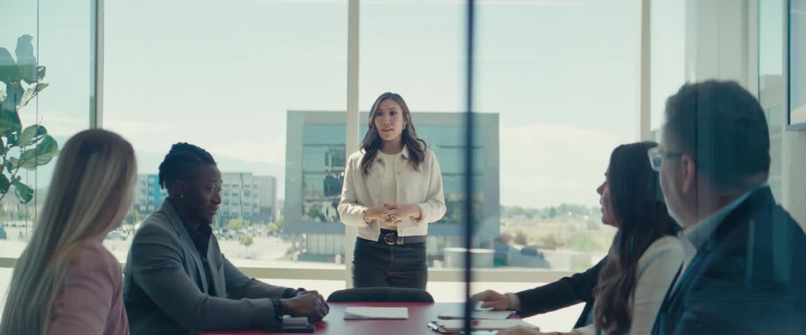 Woman standing talking in a meeting room of an office