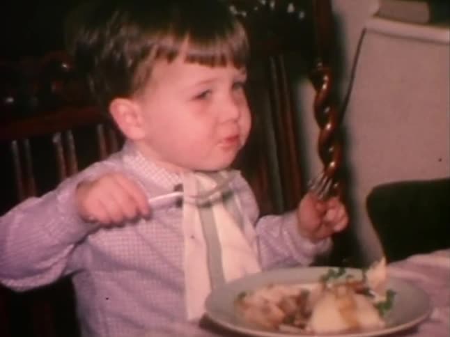 Little boy enjoys a piece of bacon