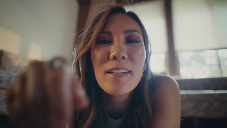 Portrait of a woman with a happy facial expression giving a smile and with her index finger interacting