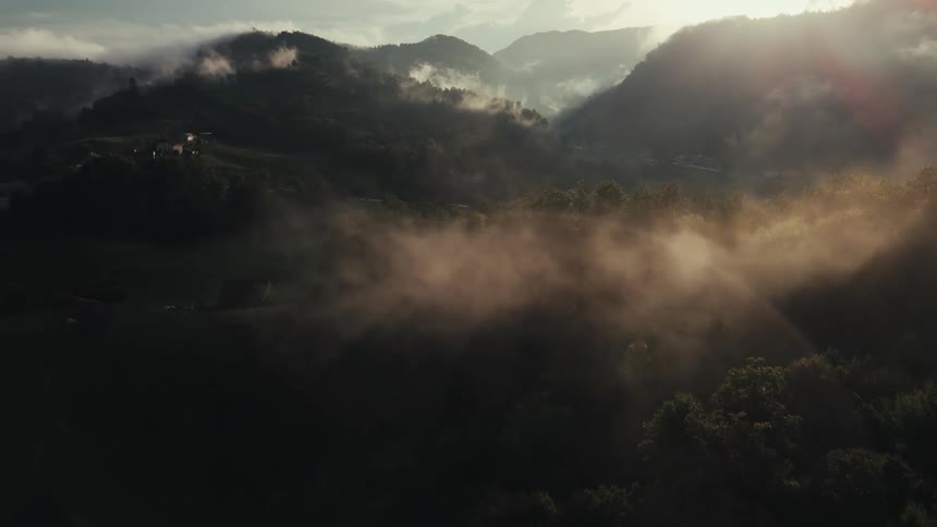 Aerial panorama of mountain hills with morning sunlight reflection