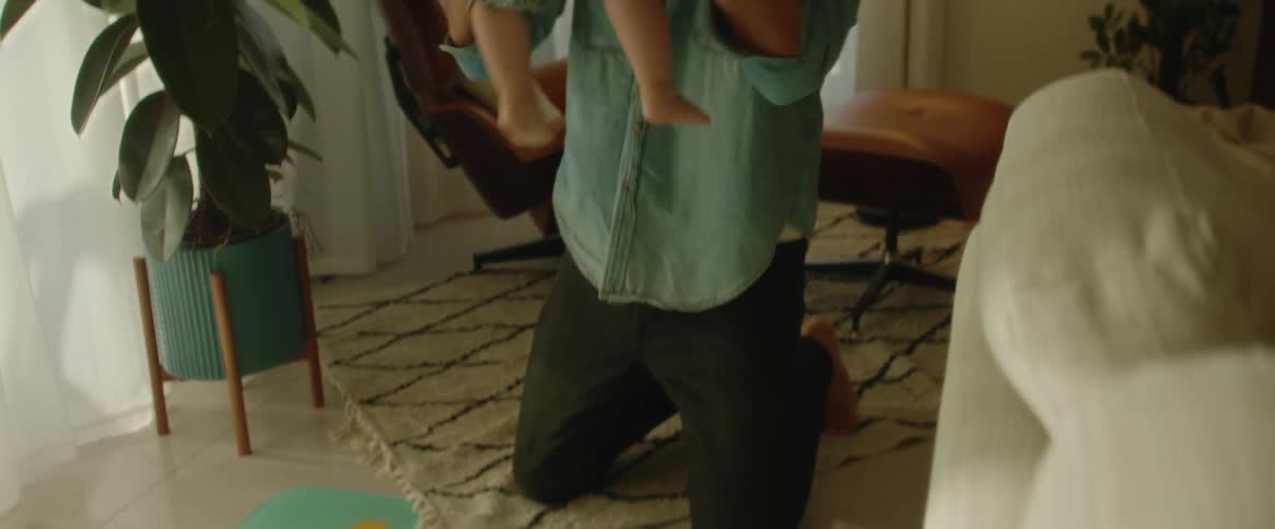 Little girl running towards her father who picks her up