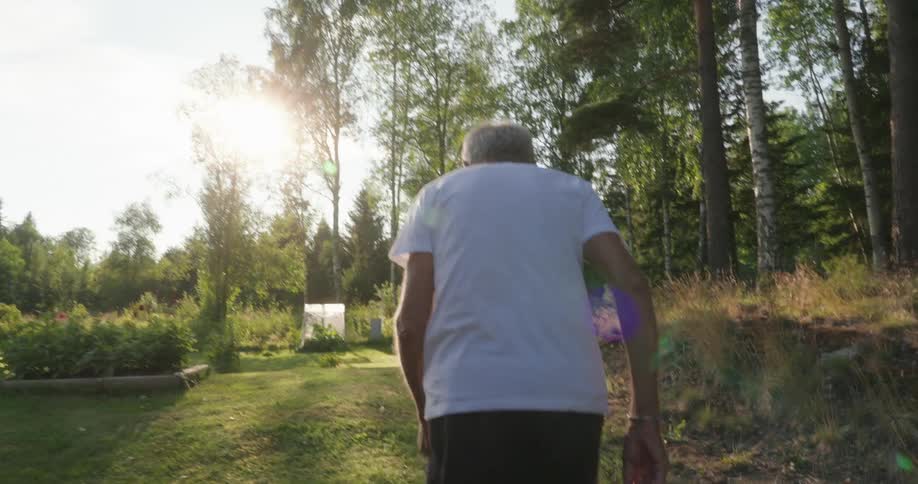 A back clip of an old man going for a run