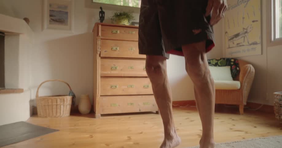 Elderly man stretching his legs by raising his feet