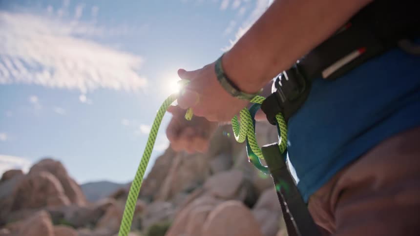 A clip of a mountain hiker dressing for climbing