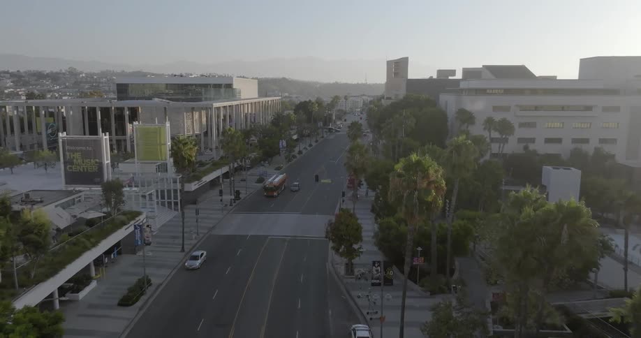 Aerial view of a road in the middle of a metropolis with the silhouette of mountains in the background
