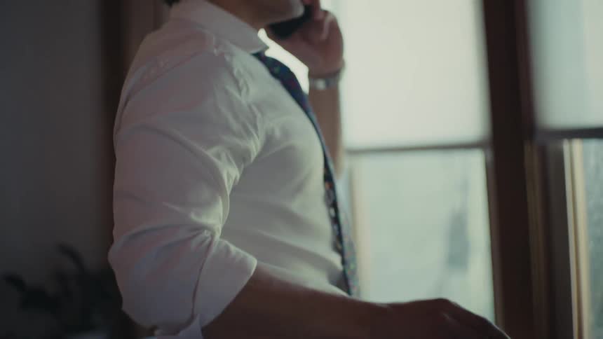 Man in shirt and tie talking on cell phone