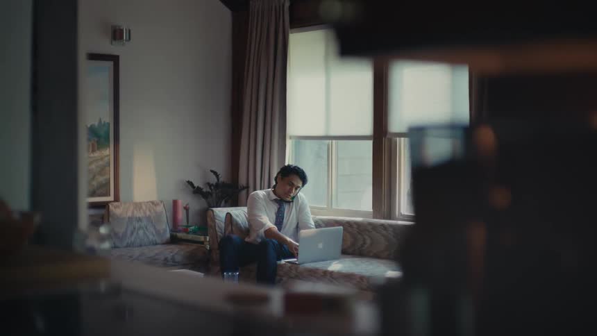 A clip of a person operating a laptop in the room