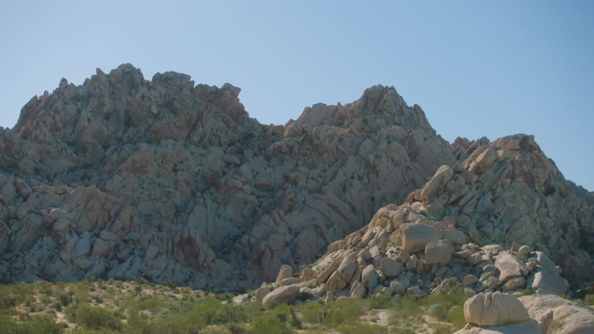 Sedimentary mountains with rocks against a blue sky