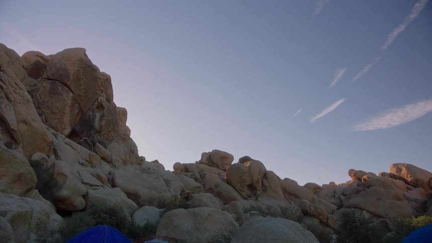 Rocks and boulders in a mountainous region before the sun rises over the horizon
