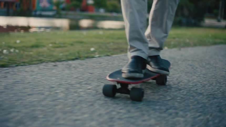 Legs of a person riding a skateboard