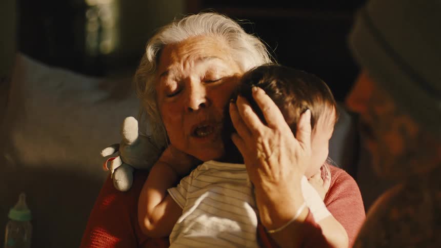 Grandmother holding a baby on her lap