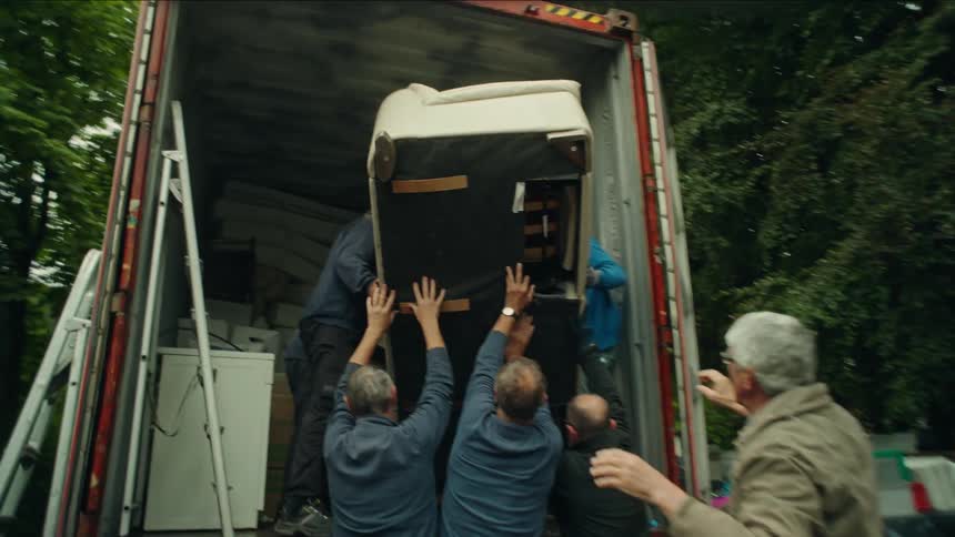 Men putting a sofa in the back of a truck
