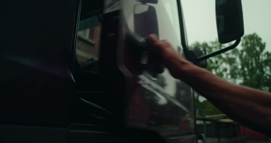 A mans arm grabbing and opening a truck door
