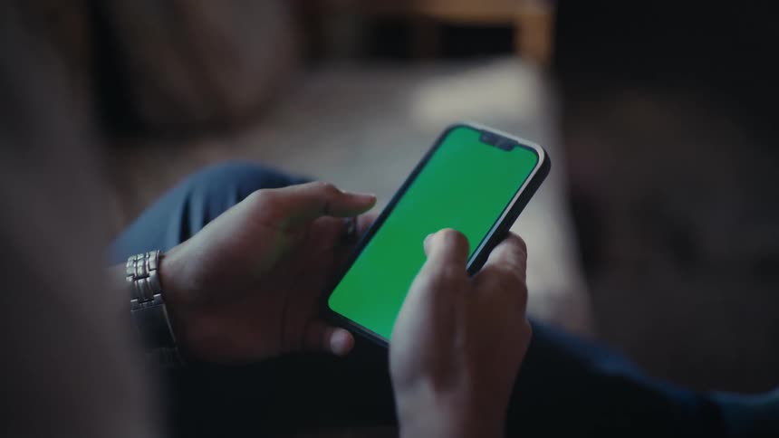 Hands of a person interacting with an iphone