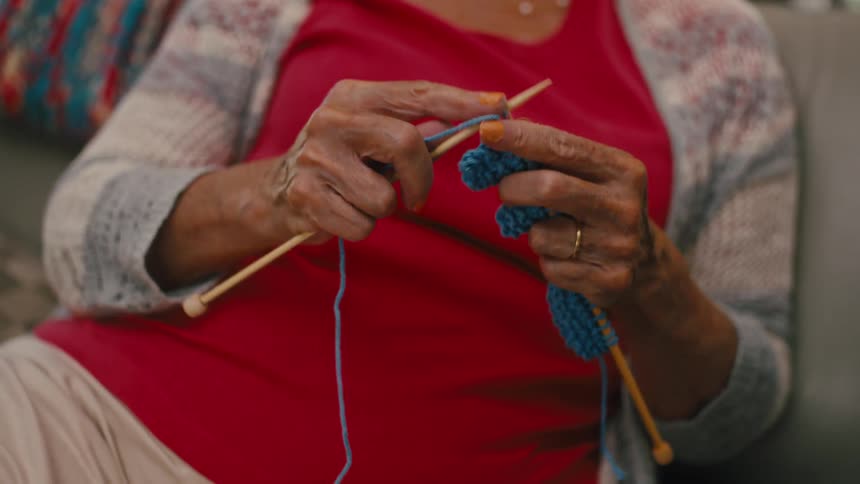 Hands of an elderly woman sewing