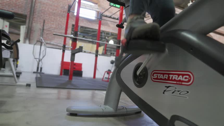 Close up of a persons feet as they pedal on gym equipment