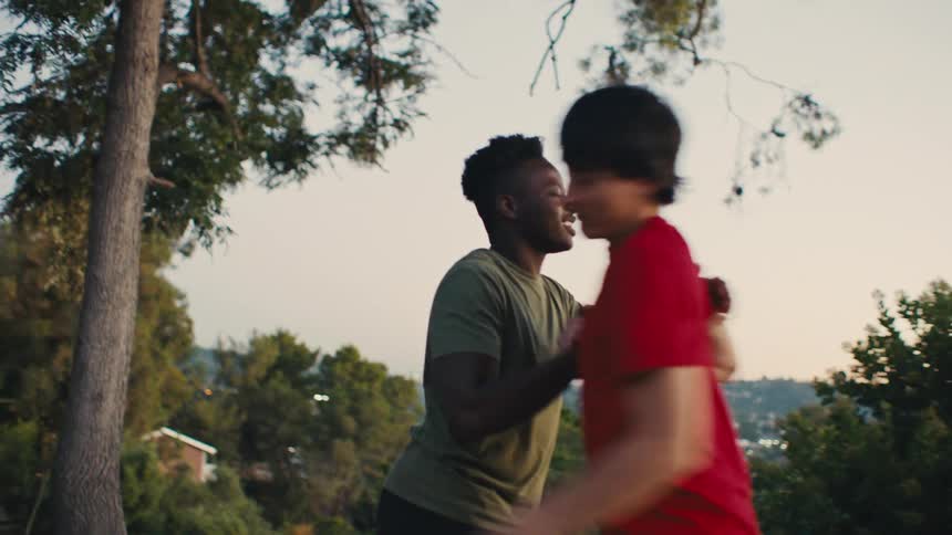 Two teenagers greeting each other and holding hands