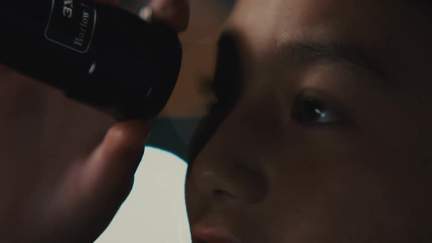Portrait of a teenage girl looking through a telescope