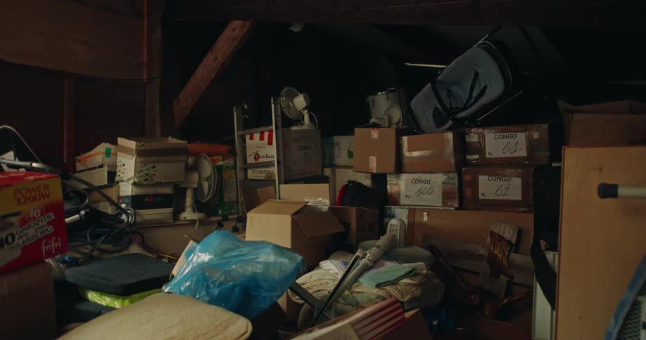 A room full of boxes and piled up junk