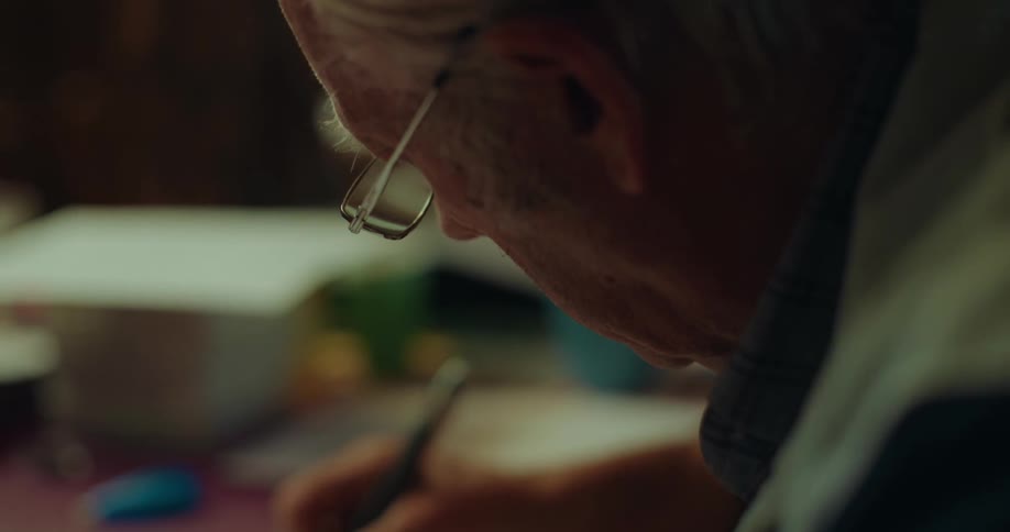 Elderly man writing