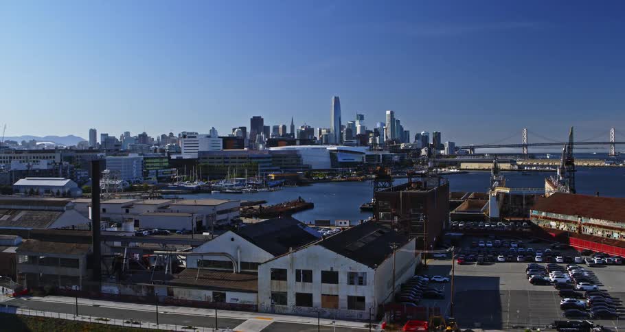 Aerial panorama of a port area and in the background a metropolis with a skyscraper