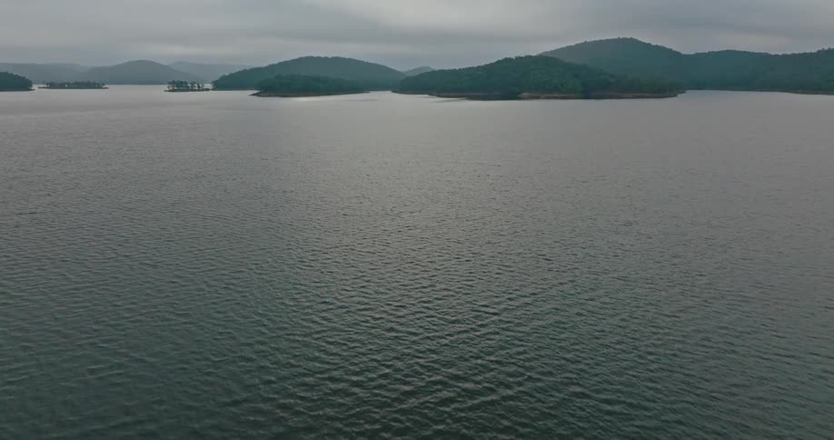 A mountainous coastline is located next to a large body of water
