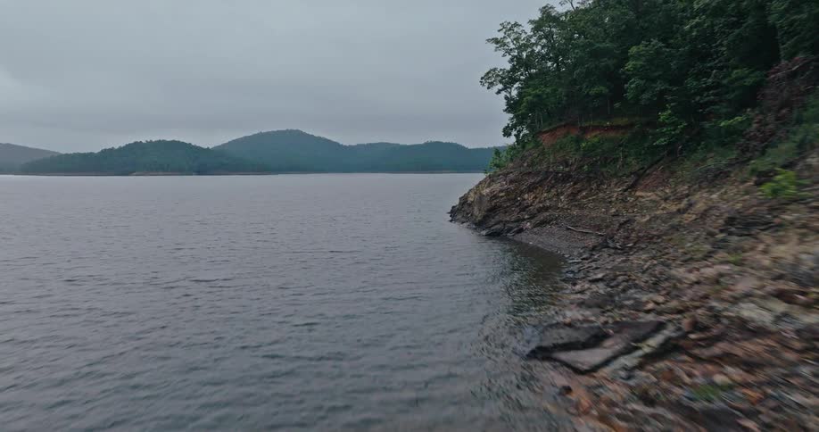 Water flows against a very rocky coastal bank in nature