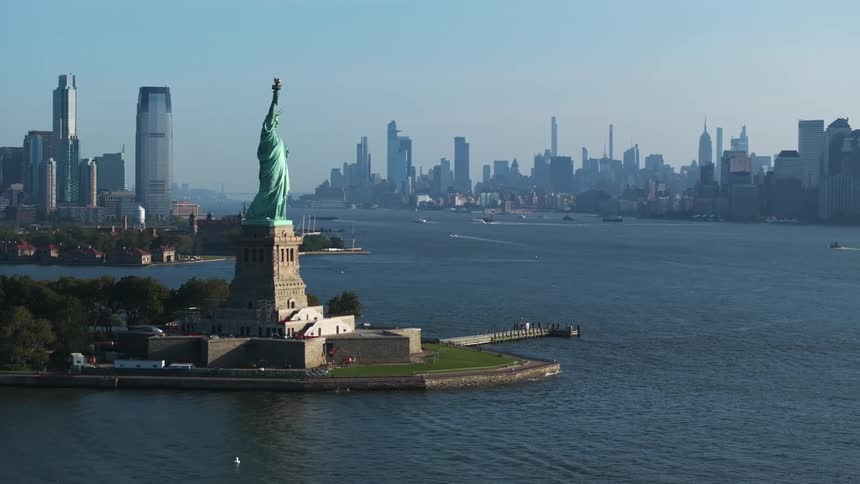 An aerial view of the statue of liberty and the new york city skyline