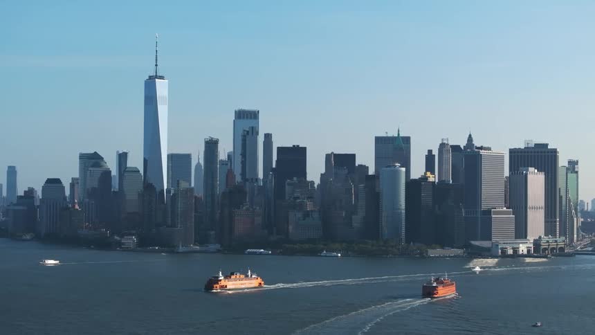 Large boats move around a city coastal area