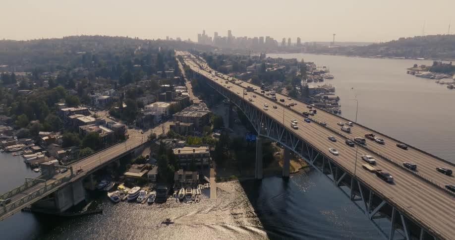 Commuters travel along the Ship Canal Bridge as wildfire smoke drifts into the city