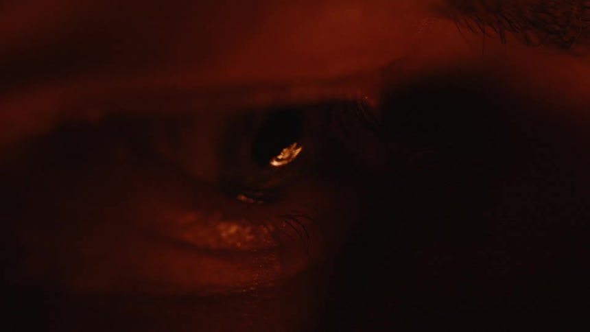 Extreme close up of a persons eye with reflection of fire flames