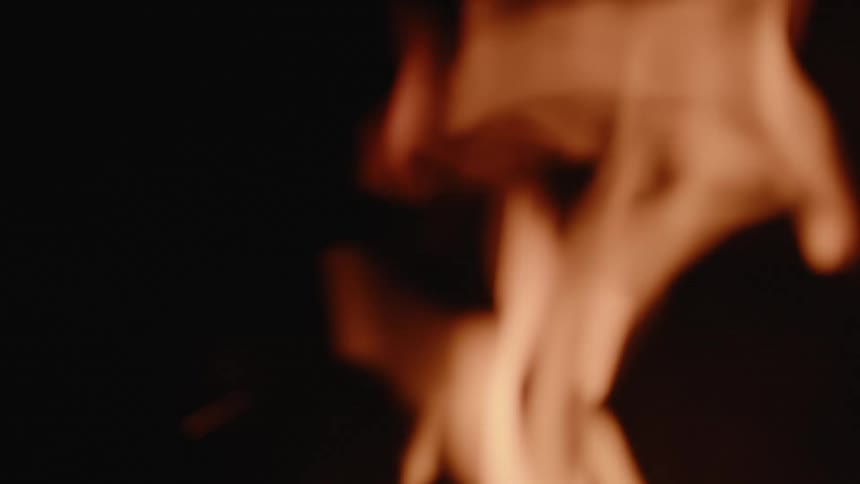Close up of fire flames rising in a dark environment