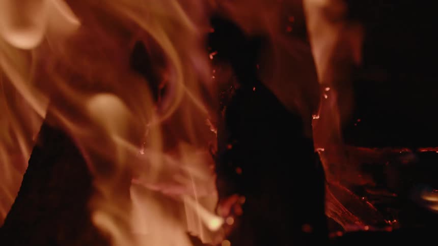 A close up of a fire with flames and embers