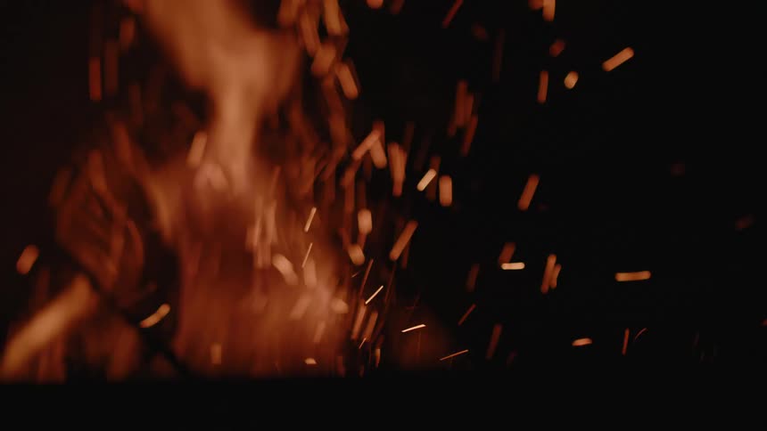 Fire flame rising with sparks at night