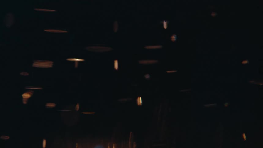 Several bright abstract objects are rotating and rising on a black background