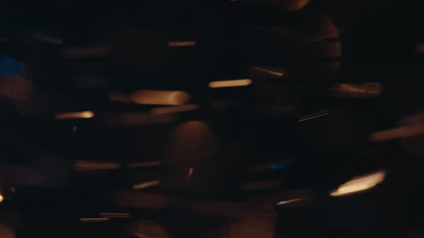 Golden discs zip by at night