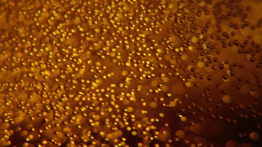 Gas bubbles inside beer rising up