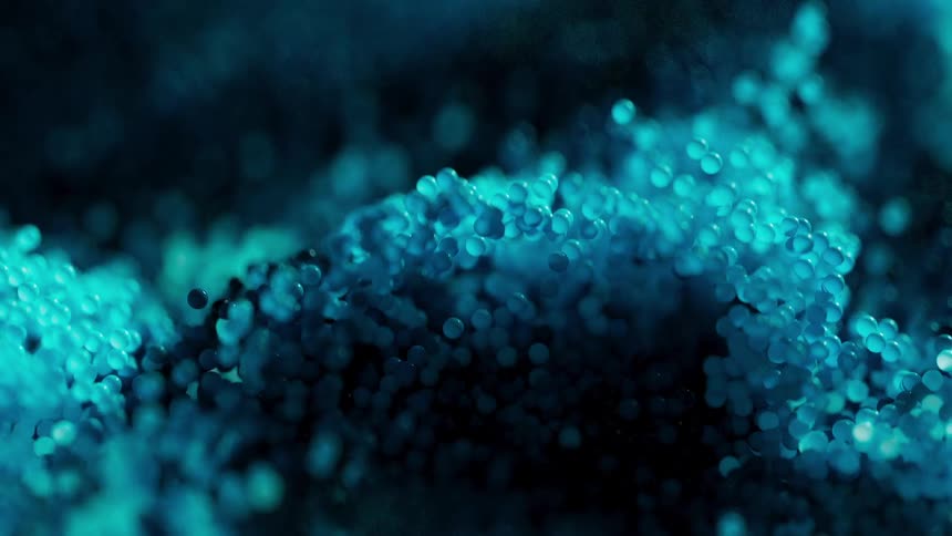 Hundreds of blue spheres moving in wave patterns