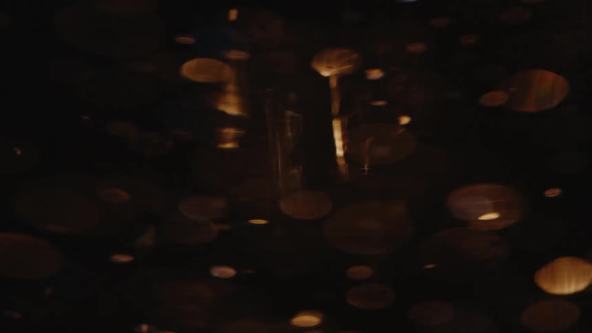 Closeup view of bubbles spinning in a liquid with light reflecting through it creating an amber glow