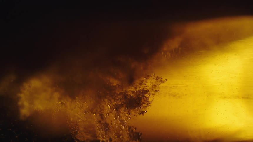 Something falls into beer making gas bubbles rise towards the foam