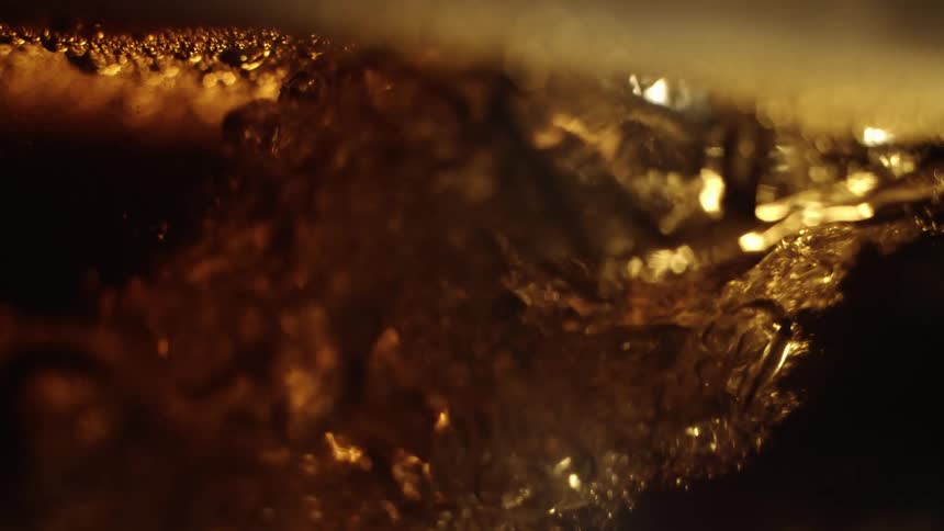 A small amount of beer poured into a container with more beer inside