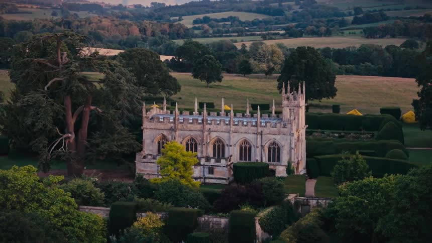 A castle sits on an estate in a rural area