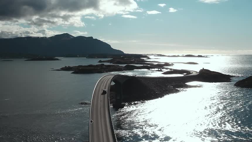 Vehicle crossing a long bridge over some open waters
