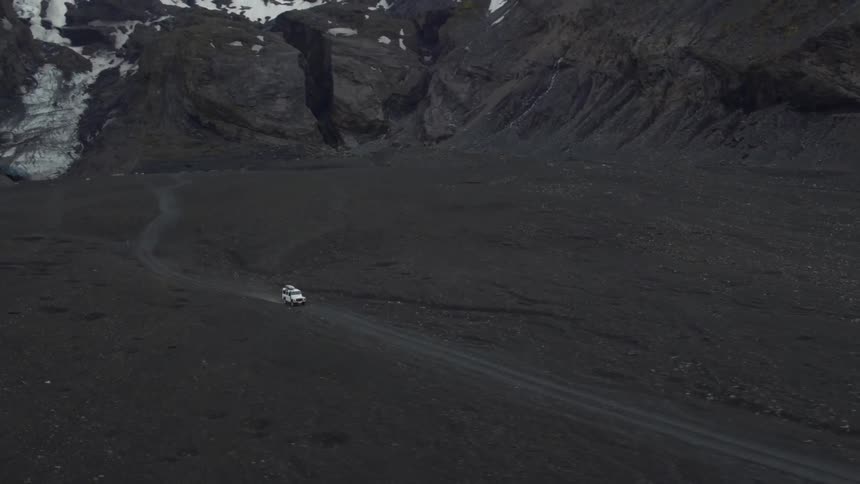 Jeep driving on a dirt road in the mountains