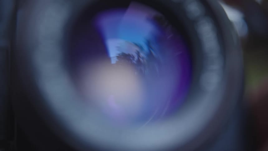 The aperture of a vintage camera lens is closing and opening up