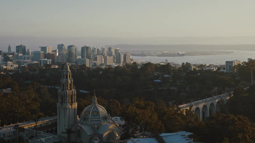 A plane flies over the city